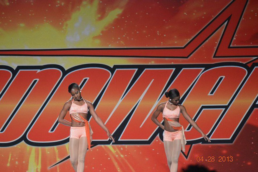 Girls performing in colorful dance costumes.