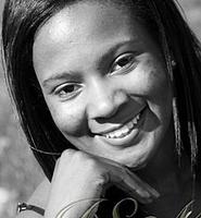Smiling woman in black and white portrait.
