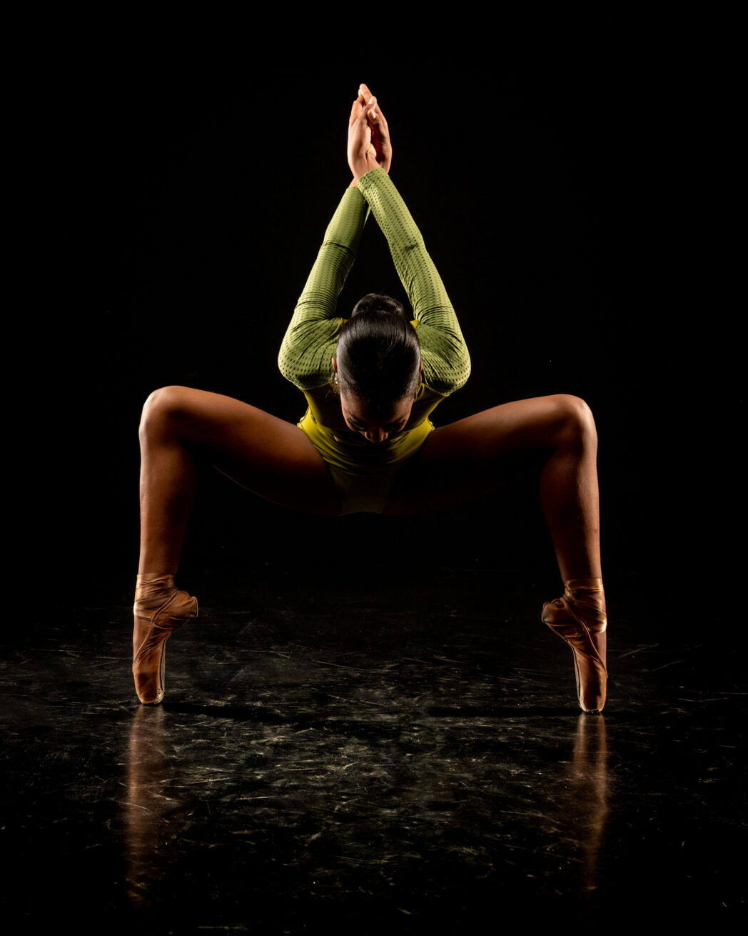 Dancer in a split pose on stage.